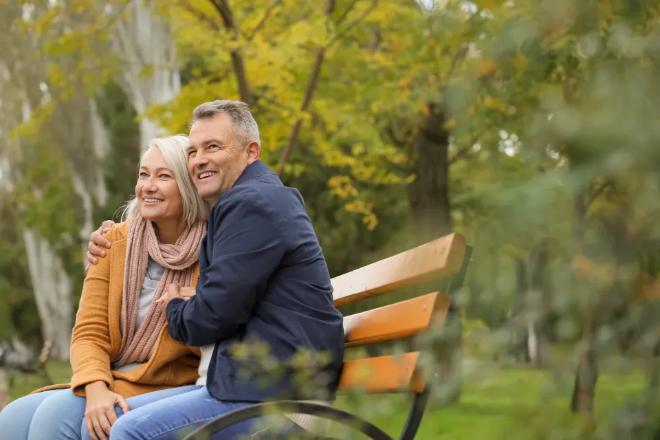 A senior couple smiling outdoors, representing cover for every life stage